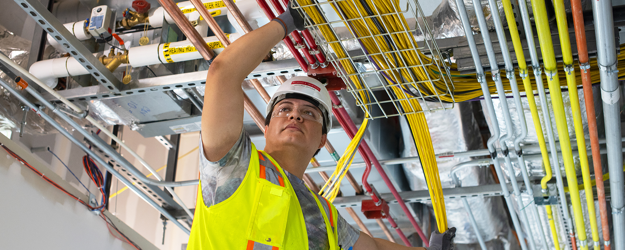 Man installing overhead conduit