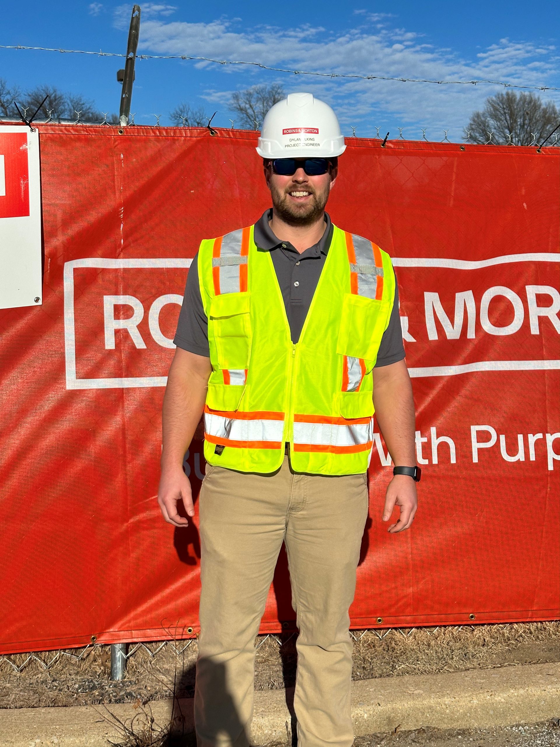 construction worker outside of construction fence