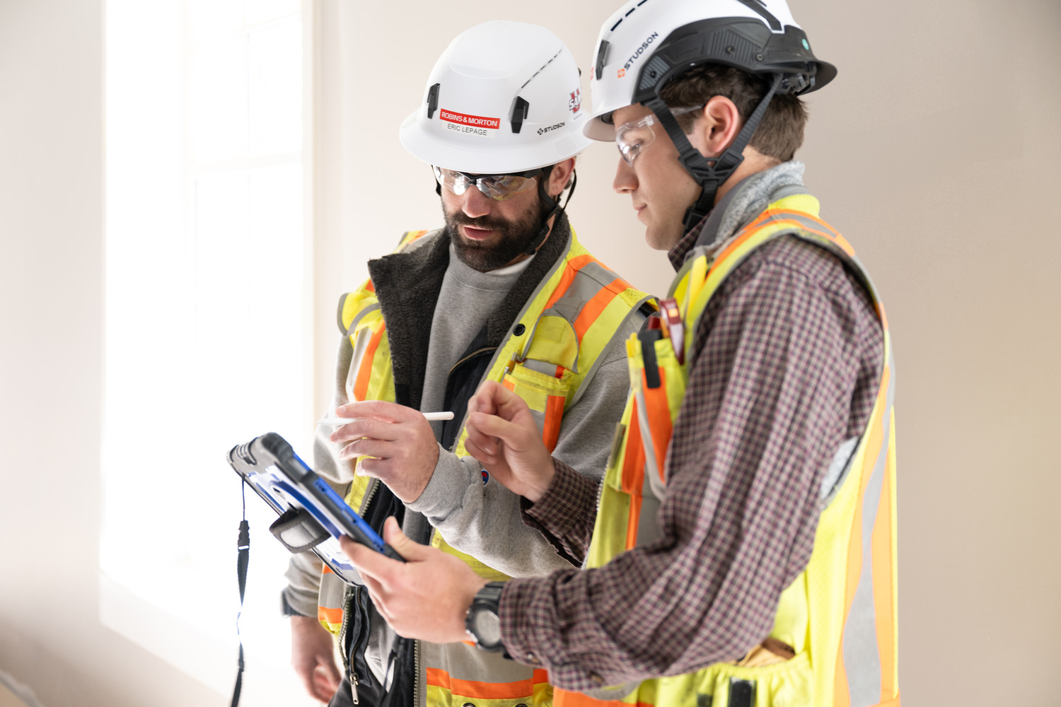 construction professionals viewing tablet