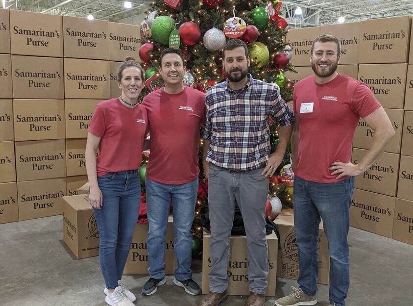 people in front of a christmas tree