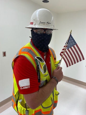 construction worker with an American flag