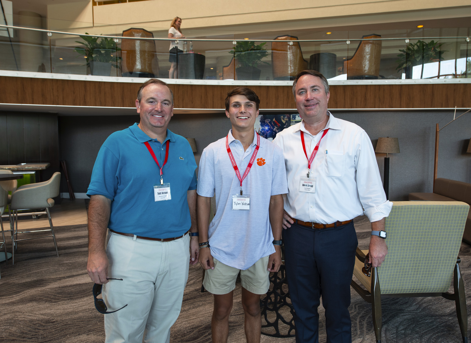 three people posing at an event