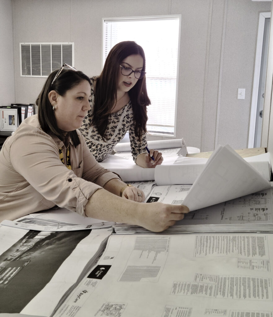 two people reviewing construction plans