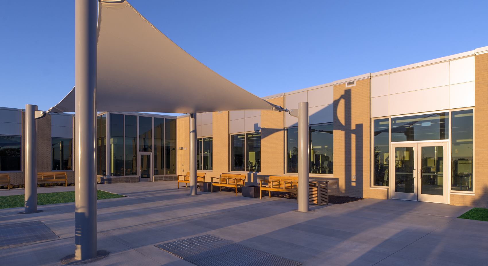 Patio with benches and canopy outside the National Intrepid Center of Excellence facility in Fort Hood