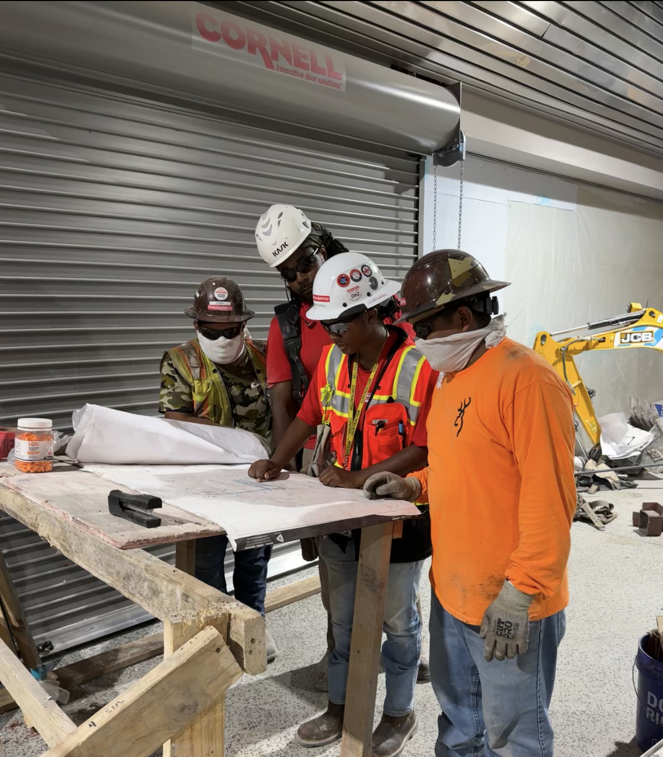 construction workers looking at plans
