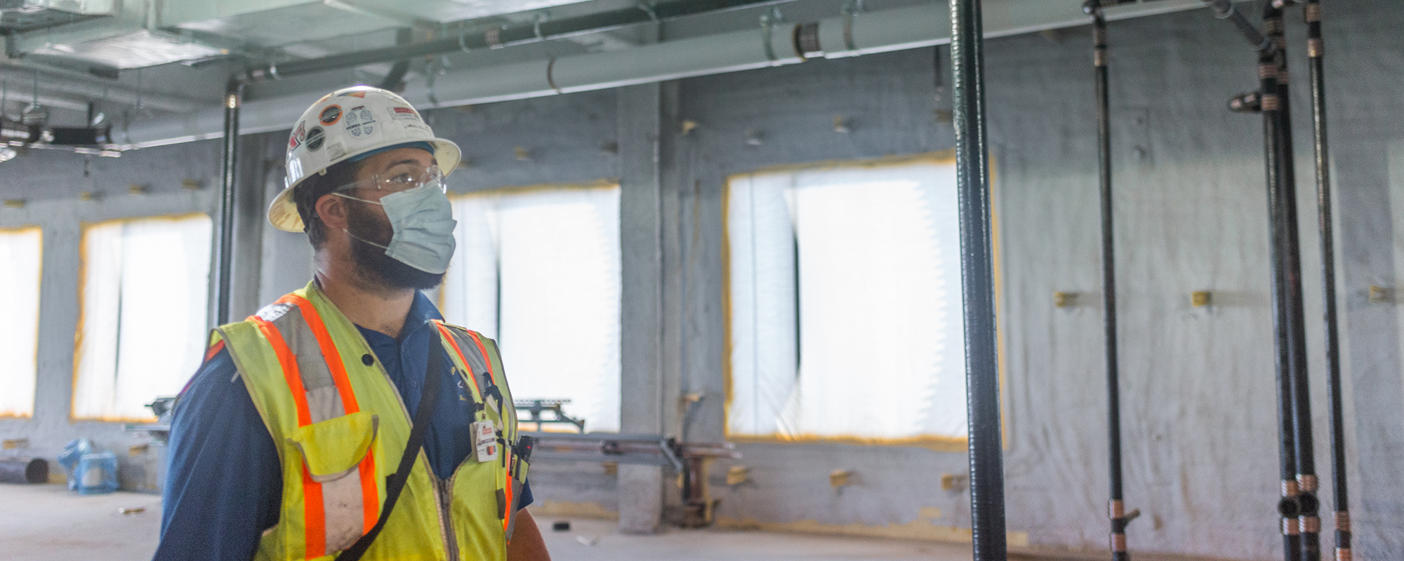 construction worker inspecting installation