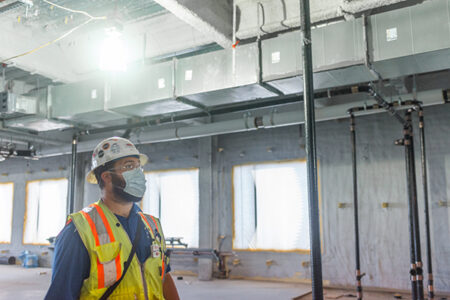 construction worker inspecting installation