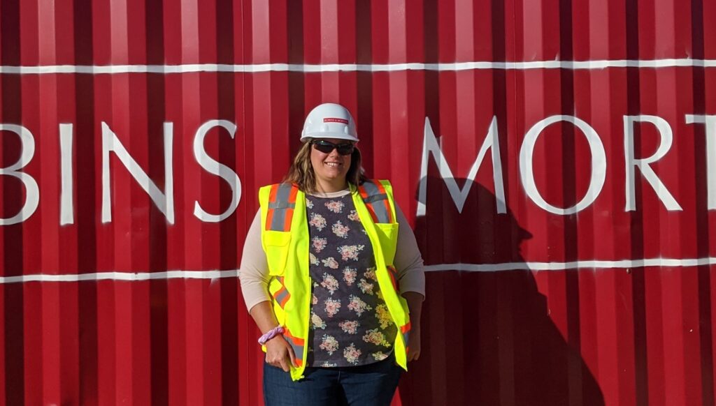 construction worker in front of a CONEX