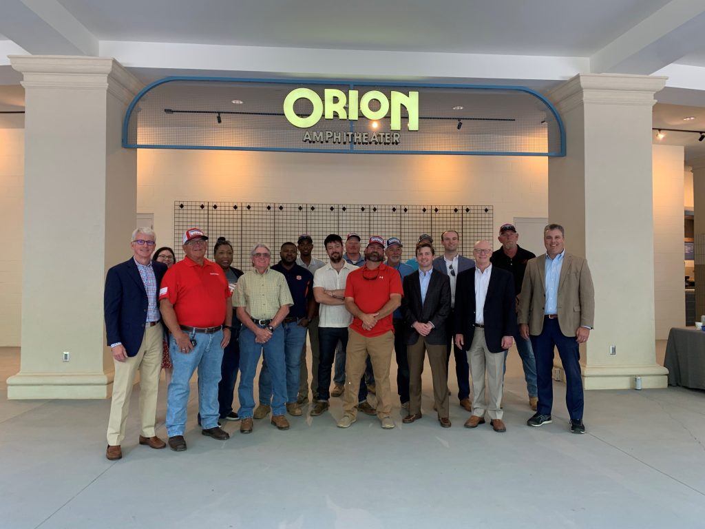 group posing under a sign