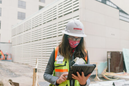 construction worker reviewing plans on her iPad