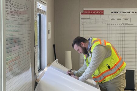 construction worker looking at plans