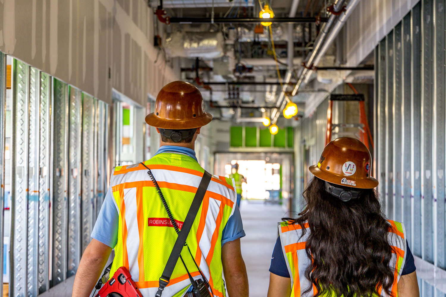 two construction workers walking on a jobsite