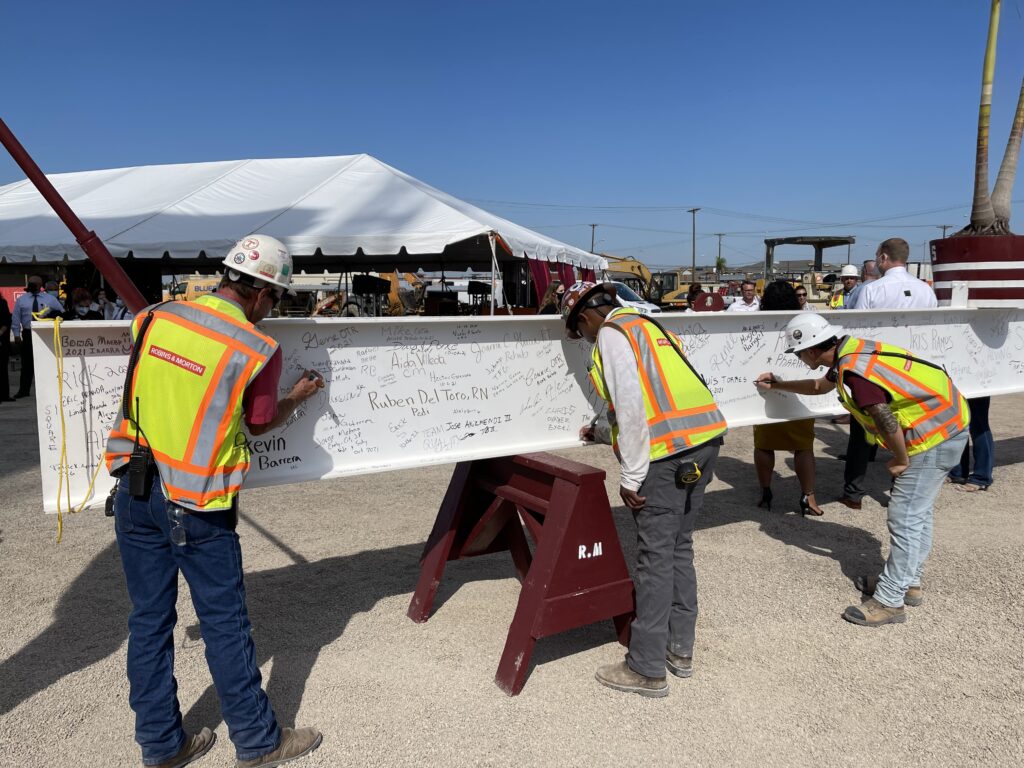 construction workers signing a beam