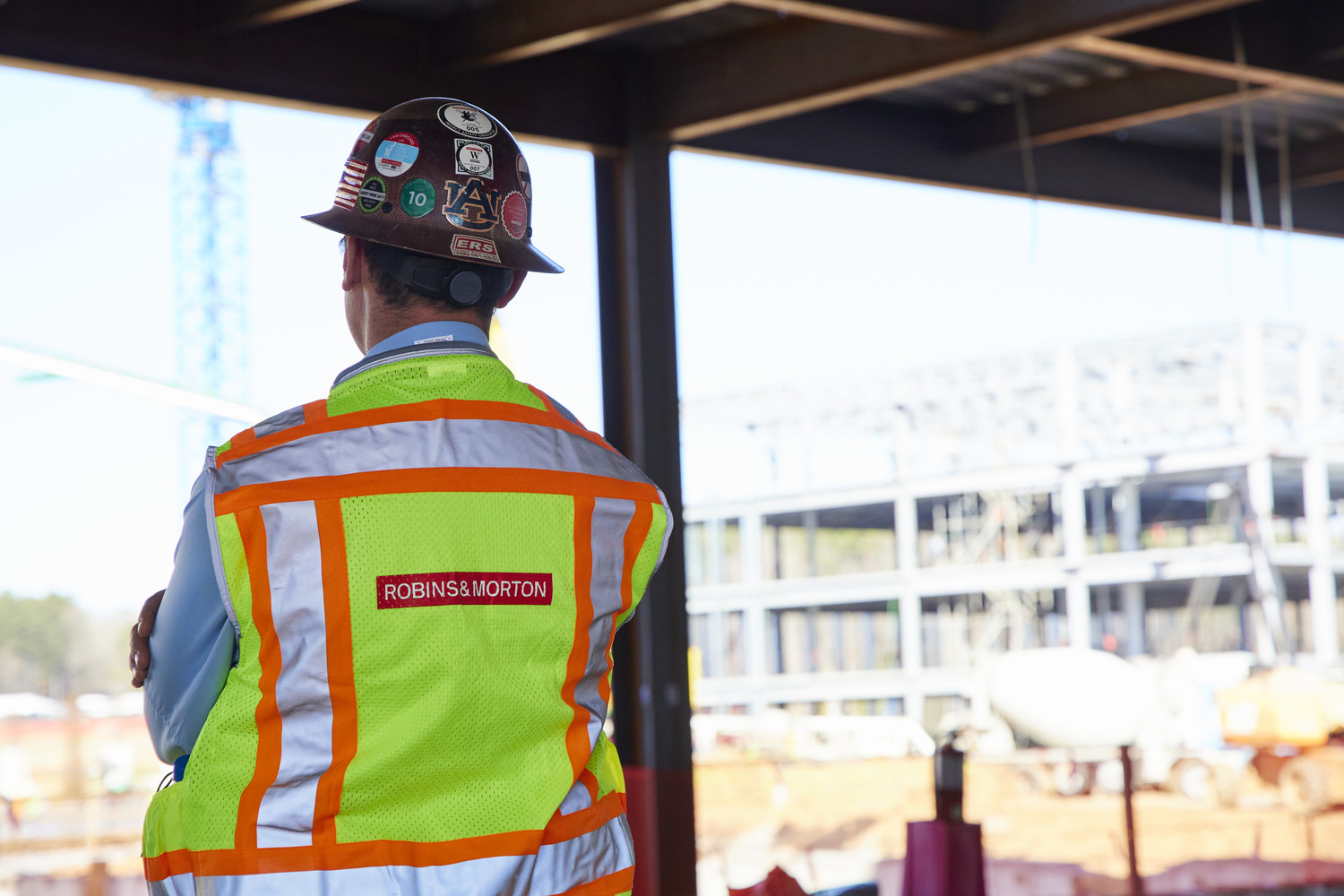 construction worker on a project site with his back to the camera