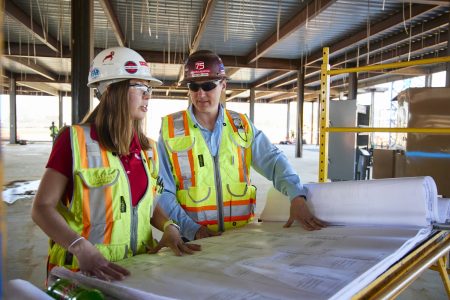 construction workers reviewing plans