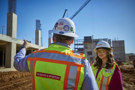 two construction workers talking on a construction site