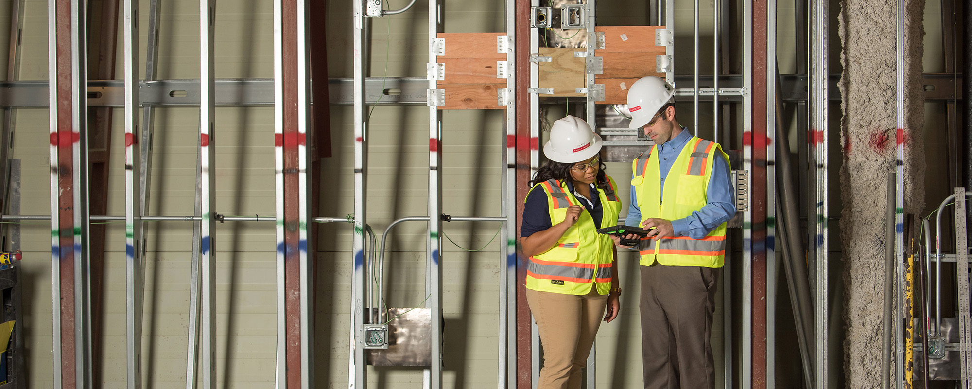 construction workers reviewing site conditions