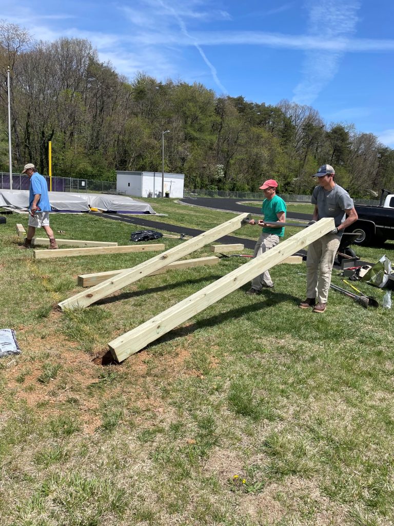 men erecting fitness equipment