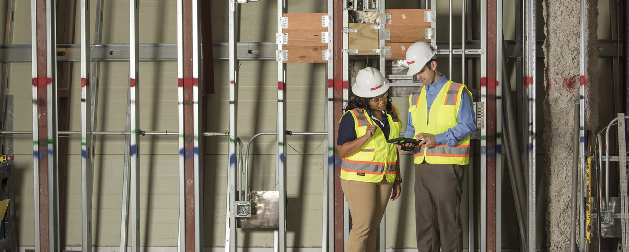 construction workers reviewing plans on an iPad