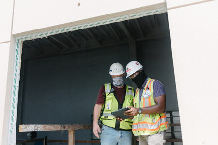 construction workers looking at an ipad