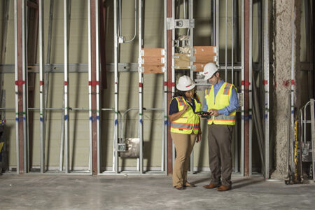 construction workers viewing plans on an ipad