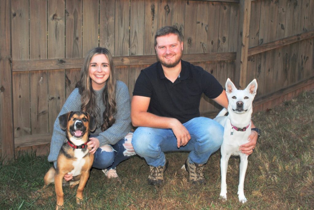 a man a woman and two dogs